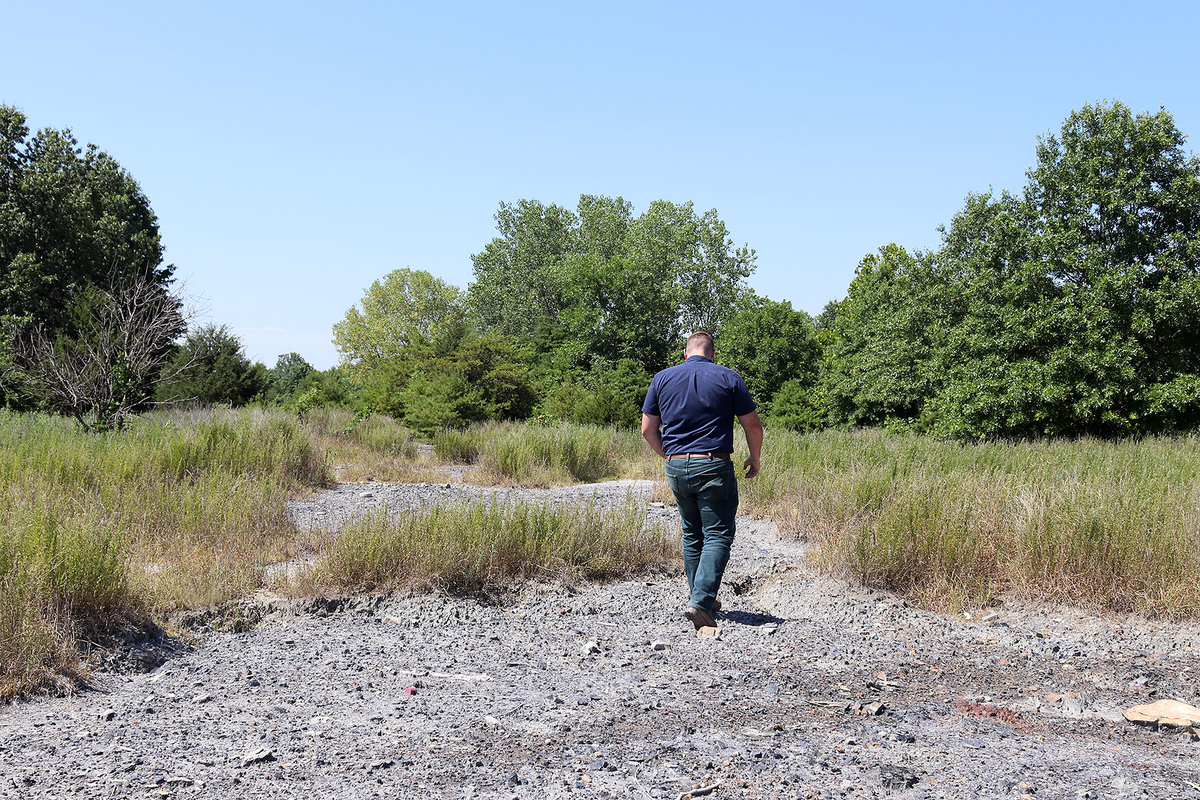 Austin Rehagen, environmental specialist at the Missouri Department of Natural Resources, walks on unvegetated